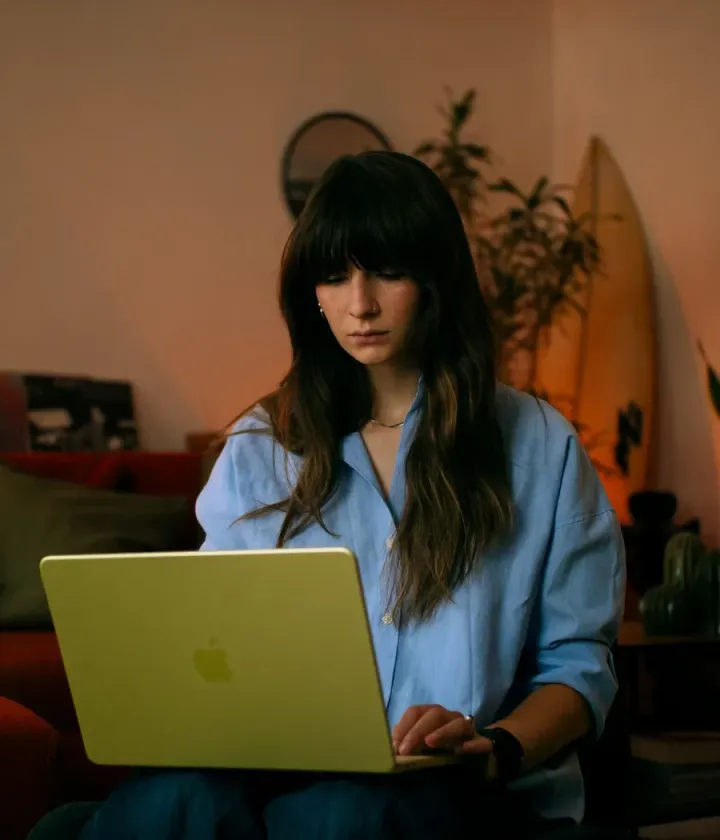 Sara working on her laptop at home